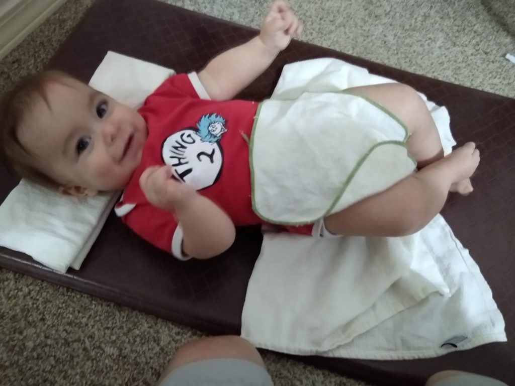 Baby on diaper changing mat